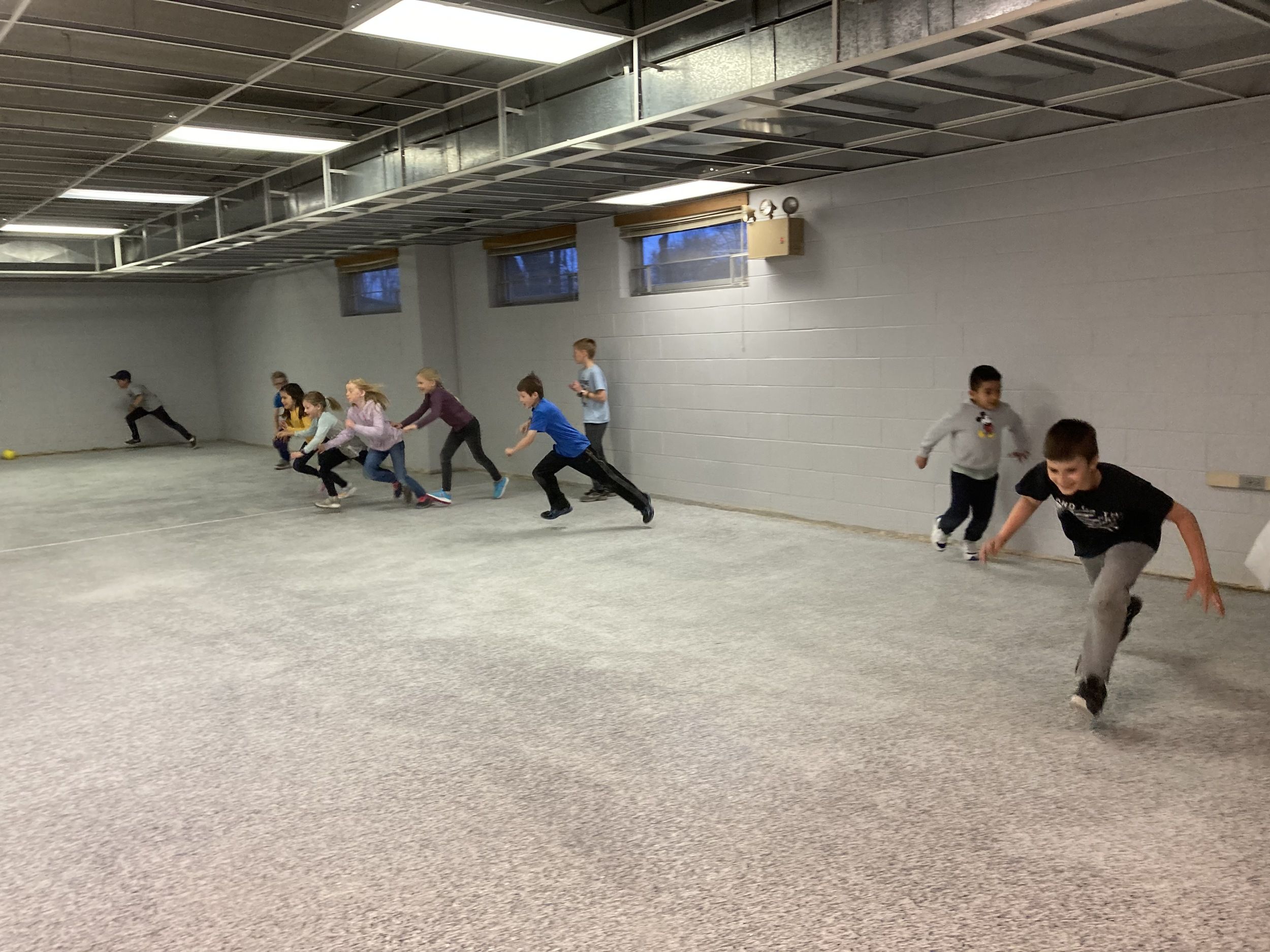 Children playing a running game in the church gym