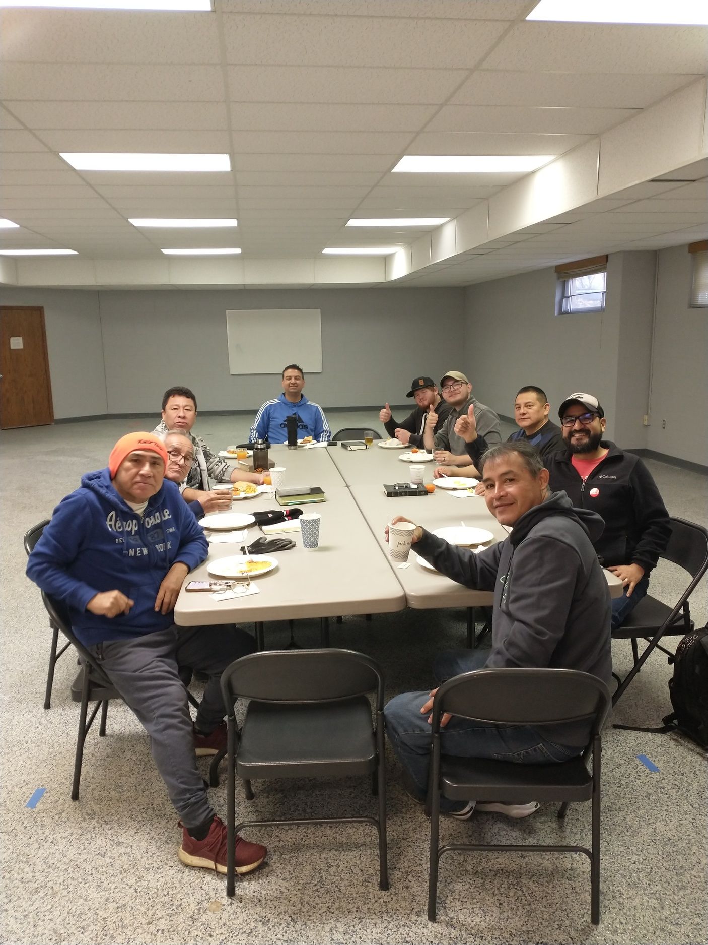 Men gathered around a table for Bible study